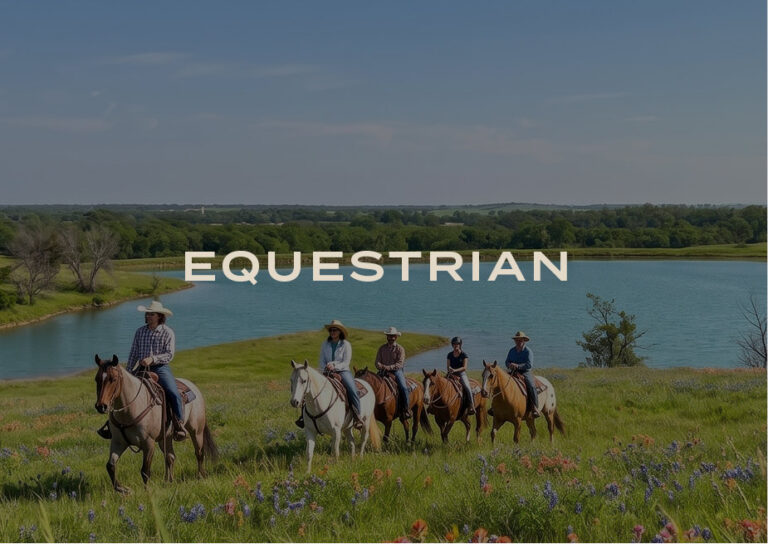 Equestrian: guests riding horses across a wildflower meadow beside a lake