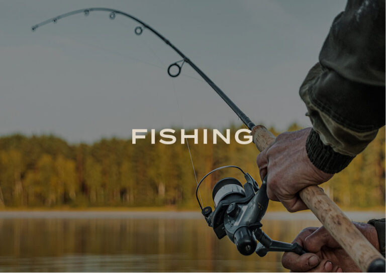 Fishing: an angler reeling in a line on a calm lake
