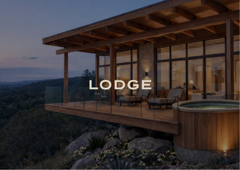 Lodge: a modern cliffside lodge with a covered deck and hot tub at dusk